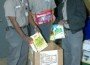 Joe Williams, Mike Nagel and Larry Scott of the Broward County Facilities Maintenance Division collect food for distribution.
